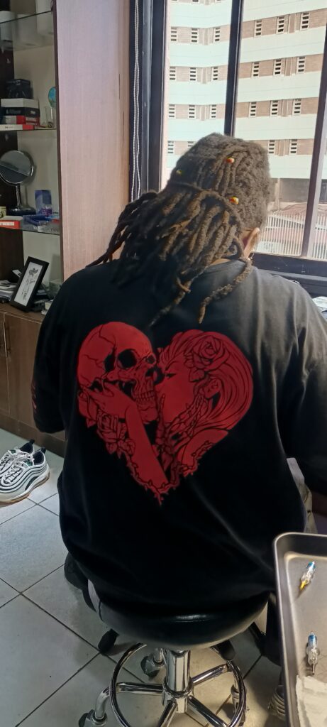 Tattoo artist inside our Tattoo and Piercing shop in Kenya